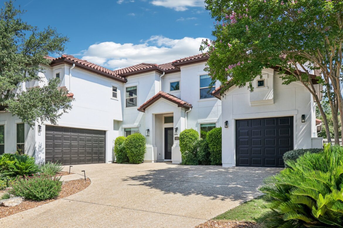 Beautiful white home surrounded by lush trees.jpg