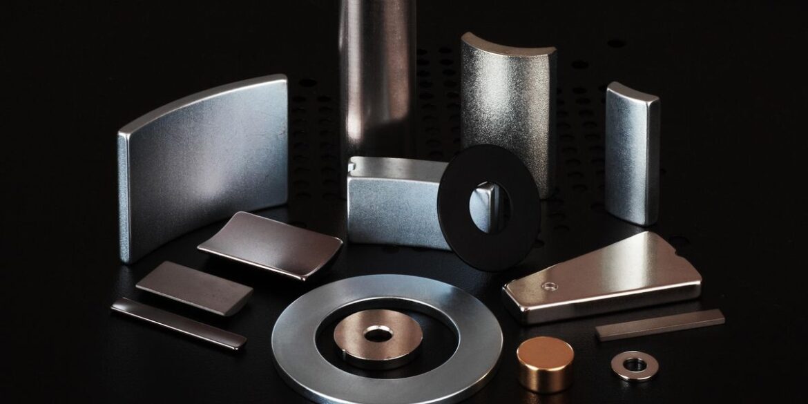 Different types of rare earth magnets laid out over a black surface.jpg