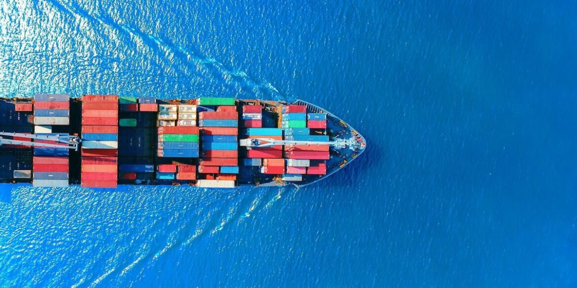 Aerial view of a cargo ship with colorful containers in vibrant blue ocean.jpg