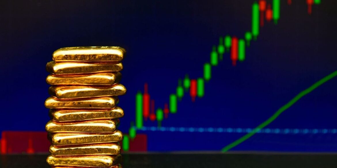 Gold bars stacked with a rising financial chart in the background.jpg