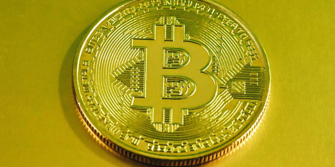Gold bitcoin coin with a digital circuit pattern on a yellow background.jpg