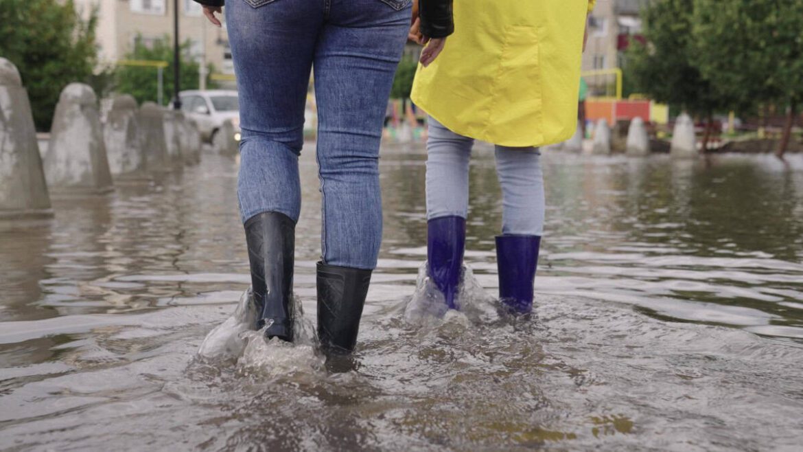 Walking through flood shutterstock 2162978205.jpg