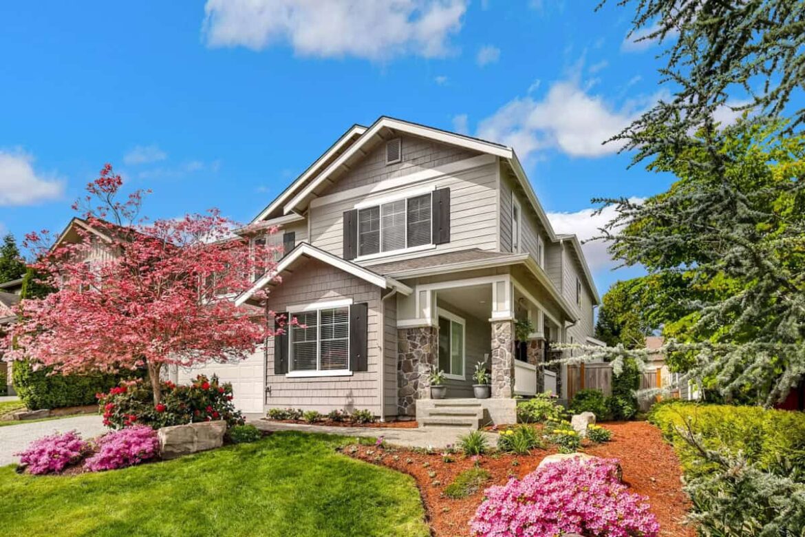 Tan house with flowers in yard.jpg