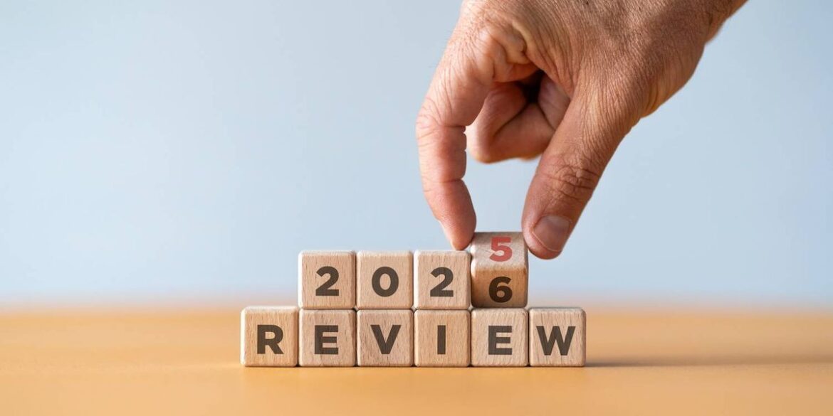 Hand changing blocks from 2025 to 2026 above the word review.jpg