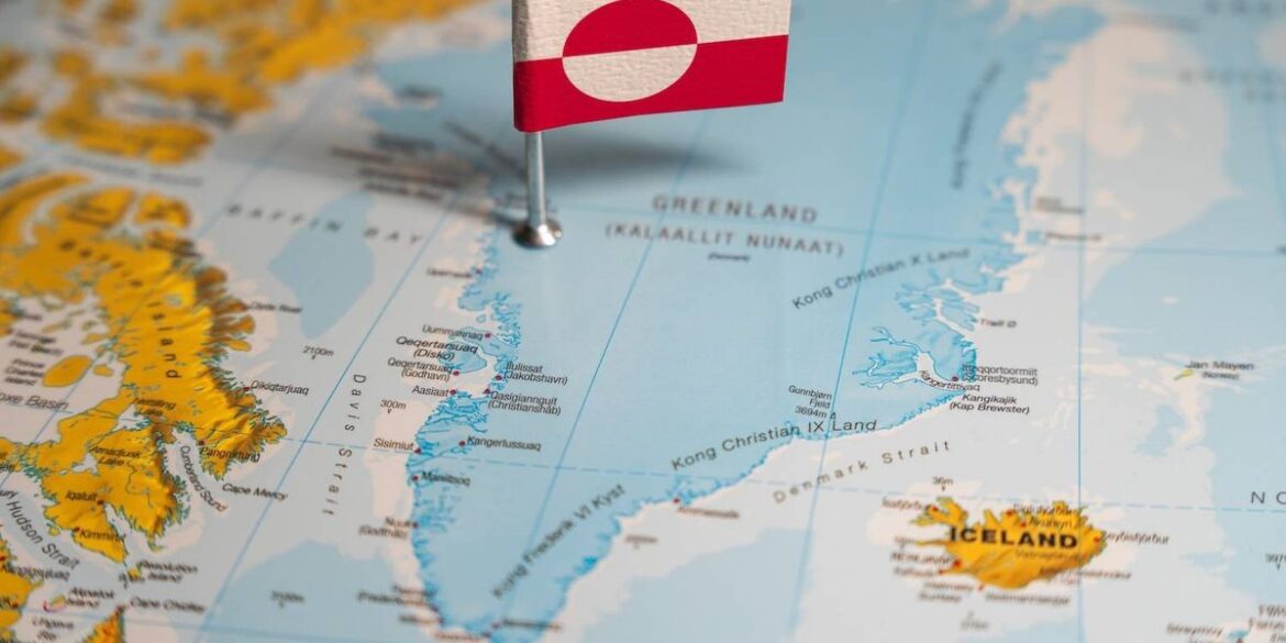 Map highlighting greenland with a flag pin featuring its national design.jpg