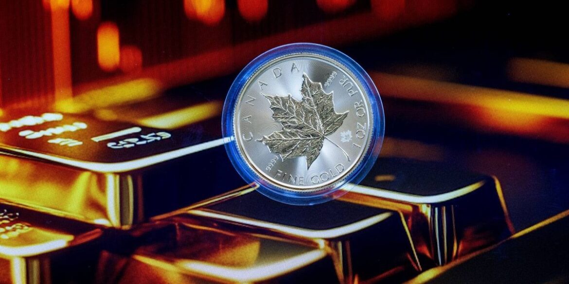 A canadian maple leaf gold coin floats over stacked gold bars with glowing red lights text reads can.jpeg