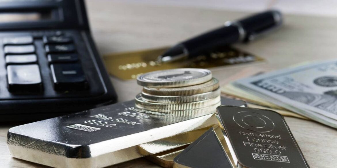 Silver bars coins calculator pen and us dollars arranged on a wooden table.jpg