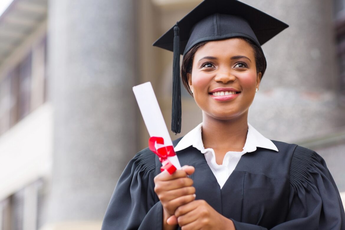 College Graduate Holding Diploma.jpg