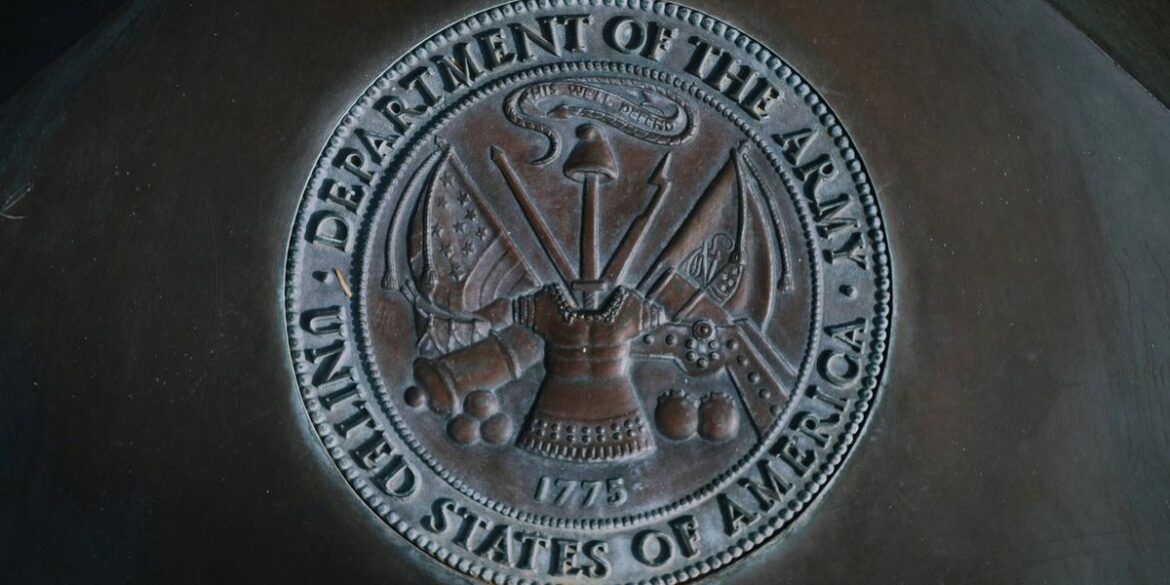 Bronze seal with insignia and weapons surrounded by text department of the army united states of ame.jpeg