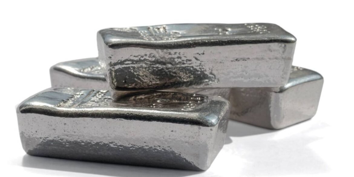 Three platinum and palladium bars stacked unevenly on a plain white surface.jpg