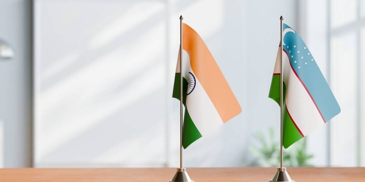 Two small tabletop flags indian and uzbekistani on a wooden surface with a blurred light background.jpeg