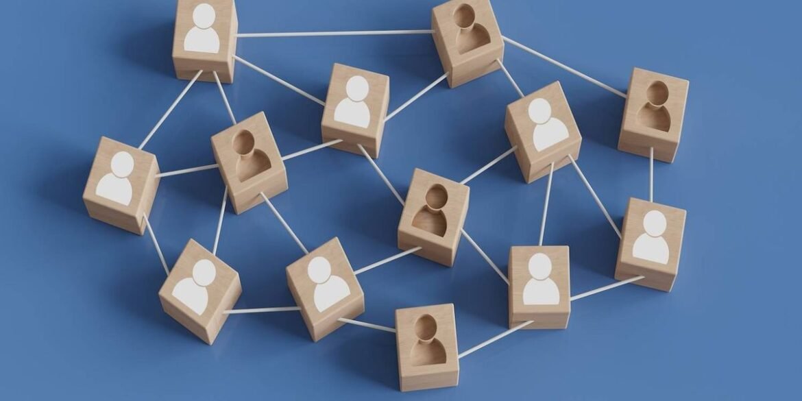 Wooden blocks with human icons are connected by white lines on a blue background.jpg