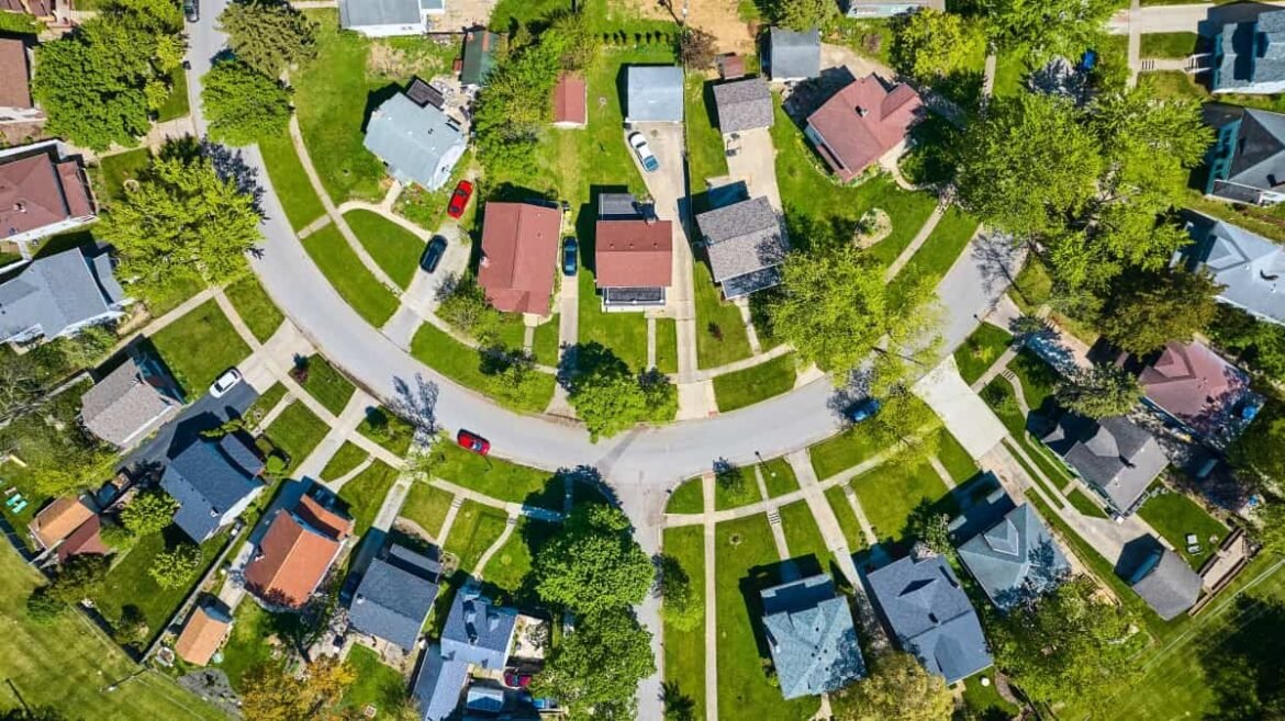 Downward view circle road in neighborhood with houses in summer aerial HOA.jpg