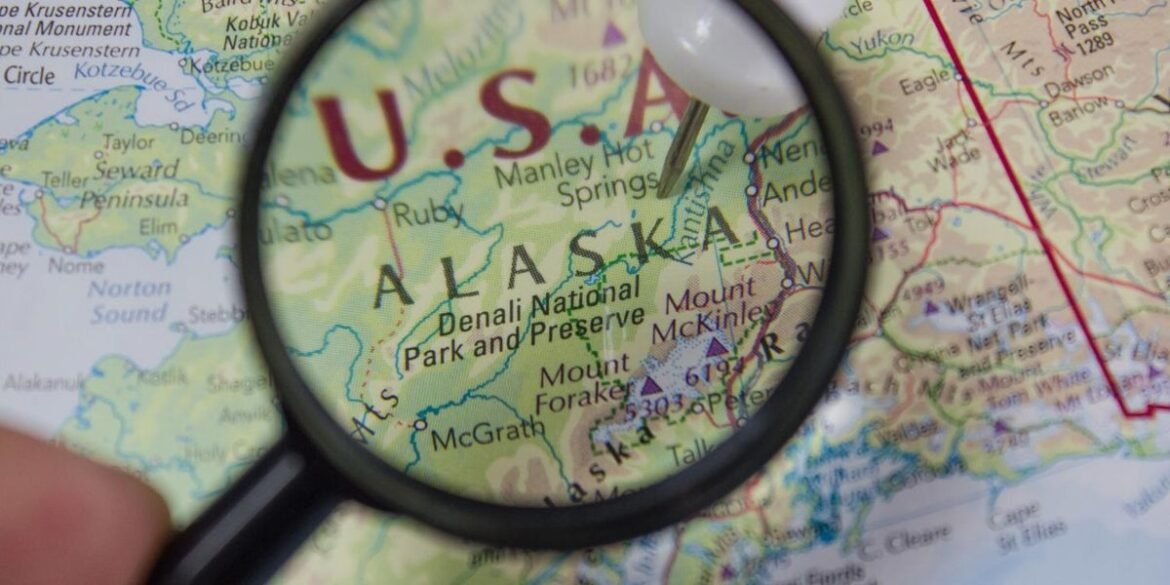 Magnifying glass highlighting alaska on a detailed us map.jpg